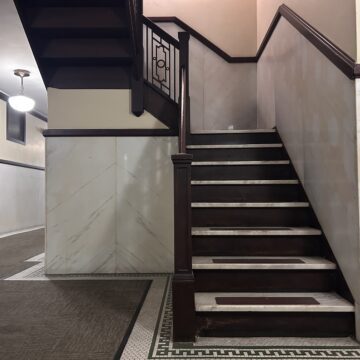 A brown and white stairway winds upwards.