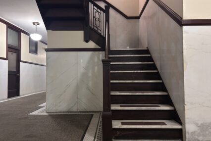 A brown and white stairway winds upwards.