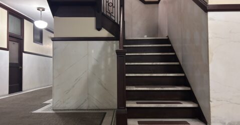 A brown and white stairway winds upwards.