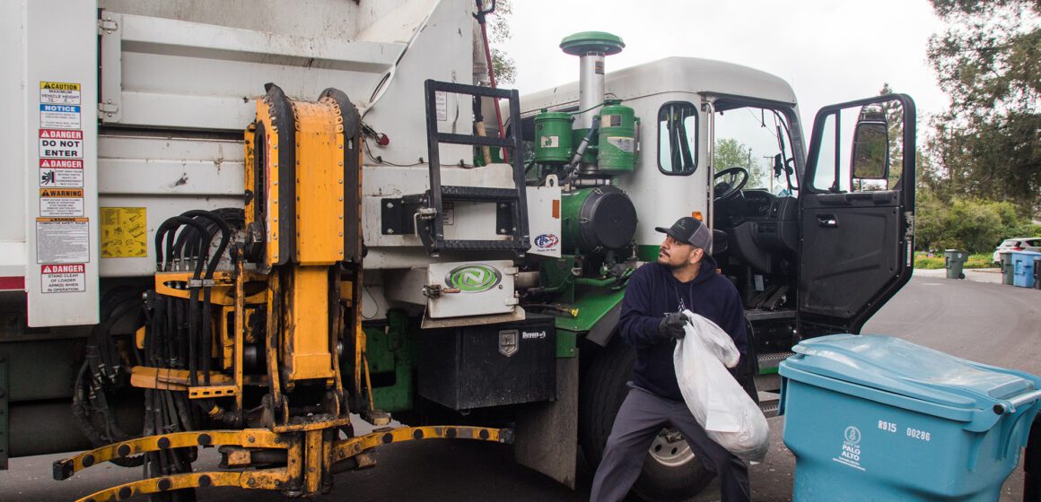 Palo Alto trash hauler Embarcadero A man tosses trash into a garbage truck in Palo Alto, California