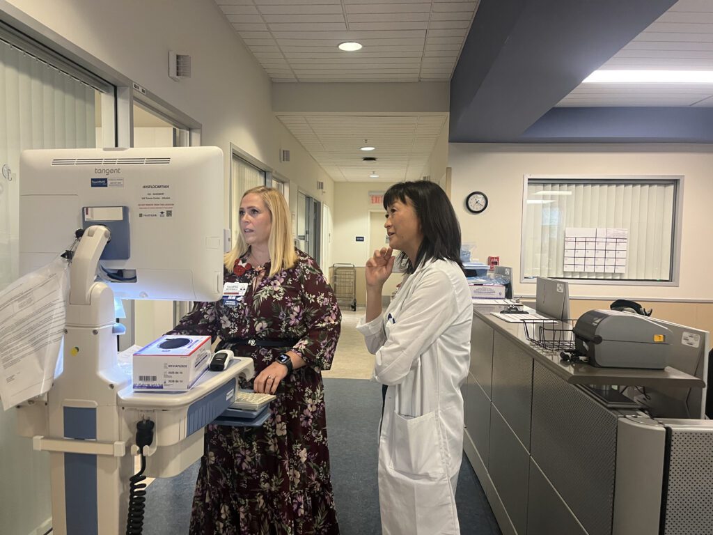 Two health care workers look at a computer in a hospital in San Jose, California