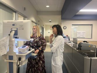 Two health care workers look at a computer in a hospital in San Jose, California