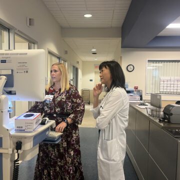 Two health care workers look at a computer in a hospital in San Jose, California