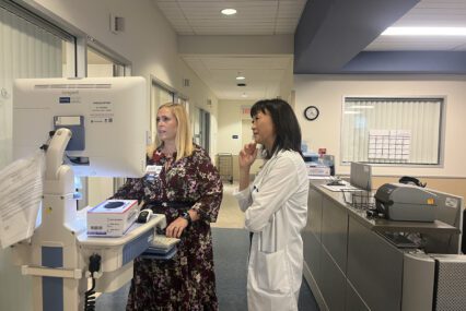 Two health care workers look at a computer in a hospital in San Jose, California