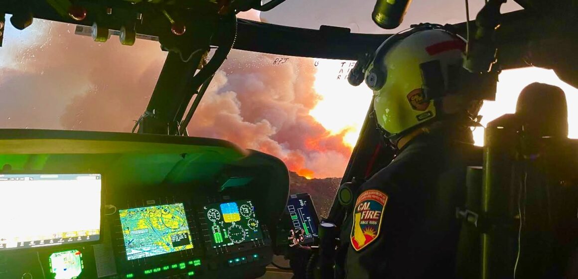 A pilot in the cockpit of a helicopter