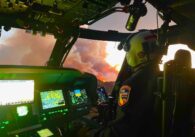 A pilot in the cockpit of a helicopter