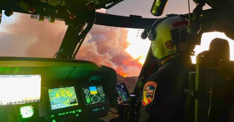 A pilot in the cockpit of a helicopter