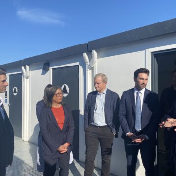 Gubernatorial tour Cherry Avenue San Jose A group of politicians standing at a homeless housing site in San Jose, California