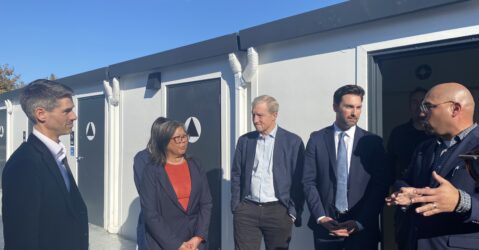 A group of politicians standing at a homeless housing site in San Jose, California