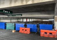 Dumpsters and barricades blocking parking spaces in a parking garage in San Jose, California