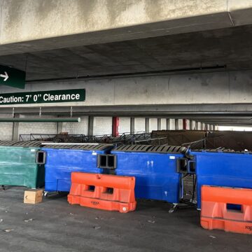 Dumpsters and barricades blocking parking spaces in a parking garage in San Jose, California