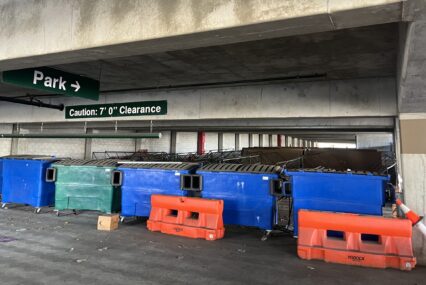 Dumpsters and barricades blocking parking spaces in a parking garage in San Jose, California