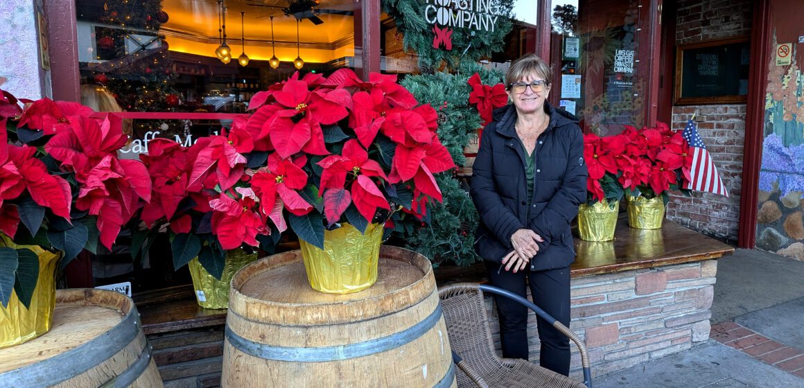 A woman stands in front of a coffee shop window in Los Gatos, California