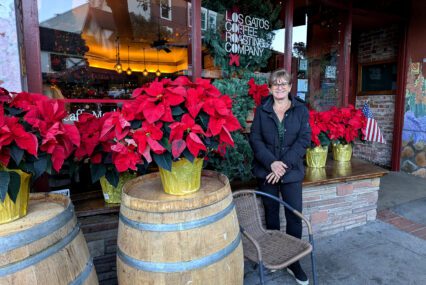 A woman stands in front of a coffee shop window in Los Gatos, California
