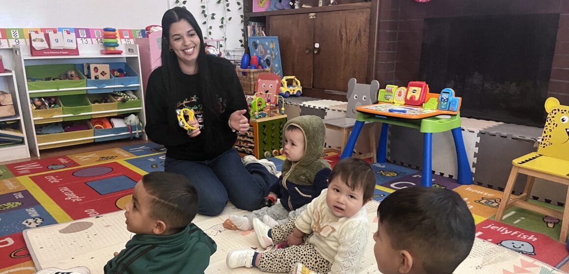 A woman playing with children in a day care