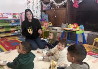 A woman playing with children in a day care