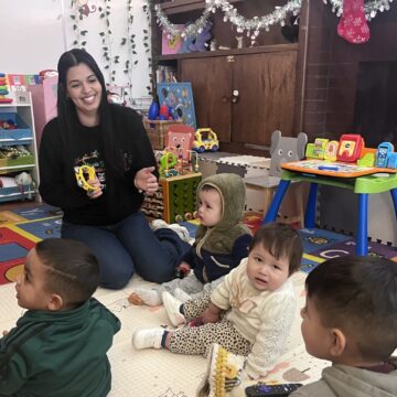 Grail Child Care A woman playing with children in a day care