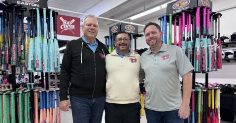 Three men standing inside a baseball shop in San Jose, California