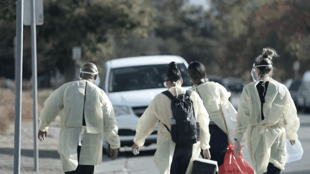 Health care workers walking outside toward a van
