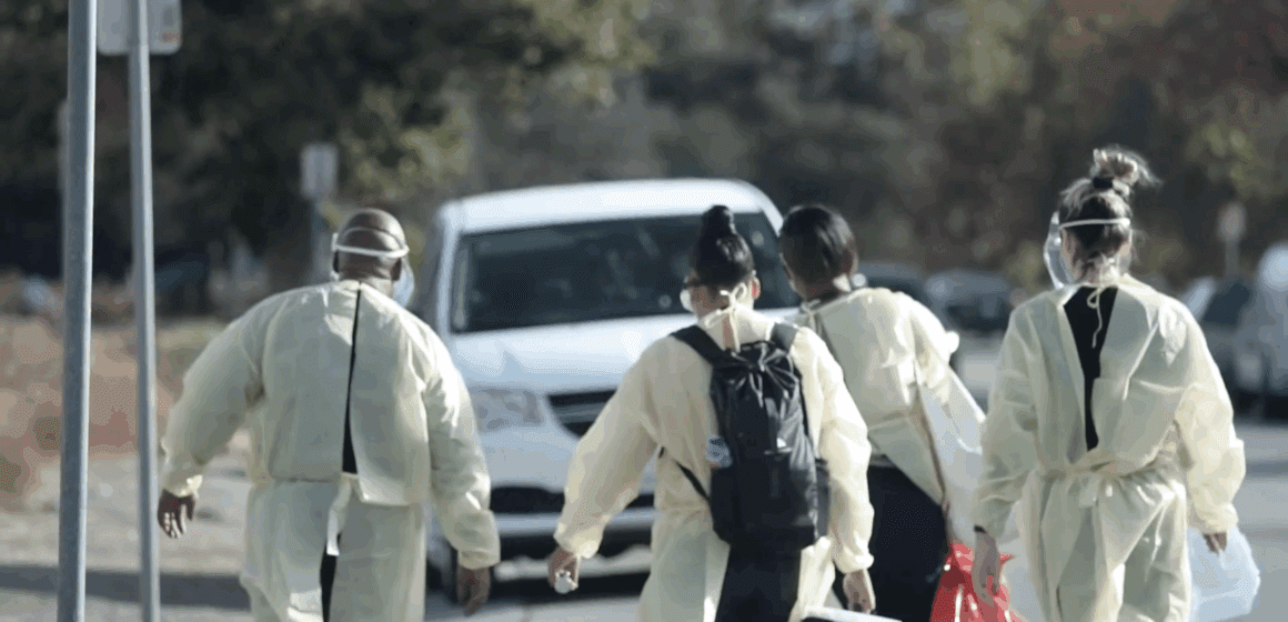 Health care workers walking outside toward a van
