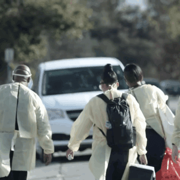 VALLEY HOMELESS HEALTHCARE PROGRAM Health care workers walking outside toward a van
