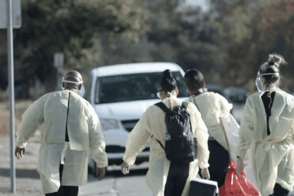 Health care workers walking outside toward a van