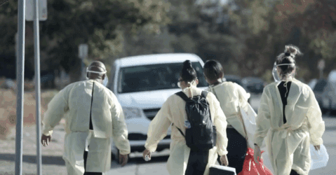Health care workers walking outside toward a van