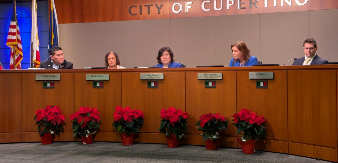 People sitting behind a dais at a government meeting in Cupertino, California