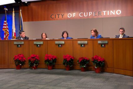 People sitting behind a dais at a government meeting in Cupertino, California