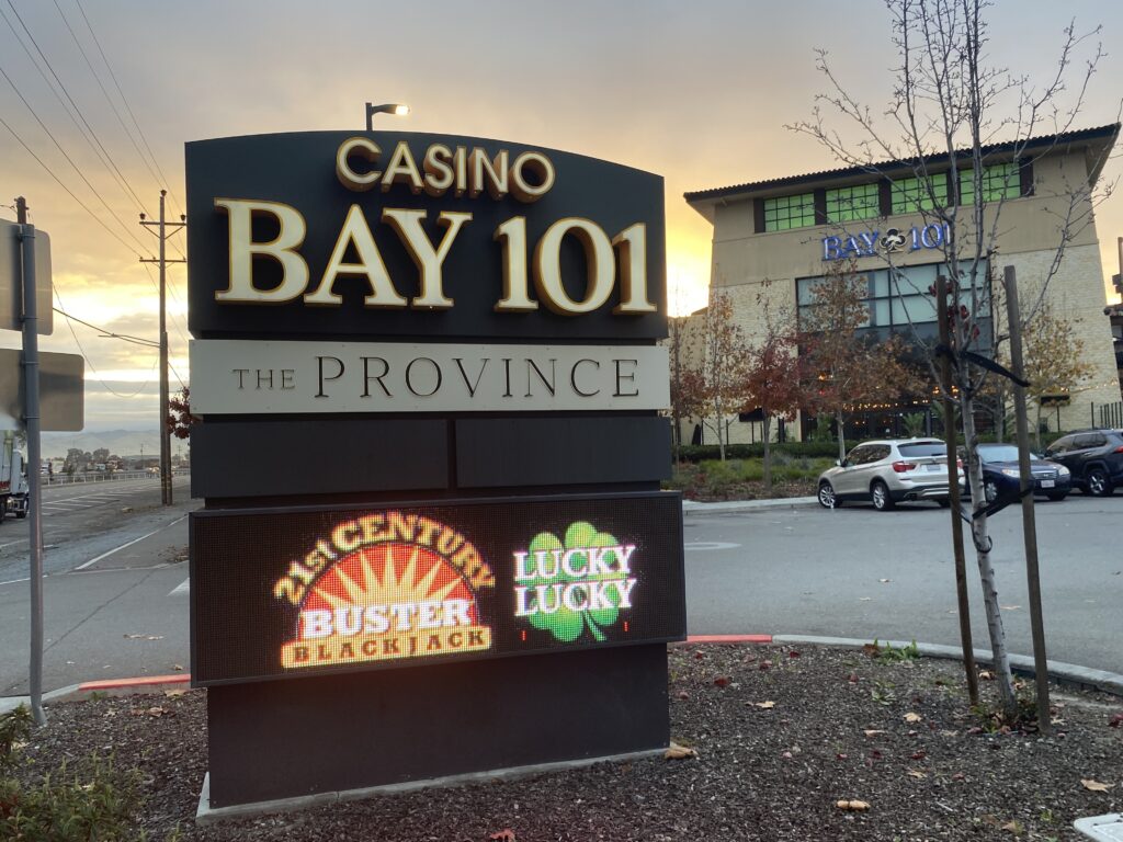A digital sign for Bay 101 Casino in front of the parking lot for the casino.