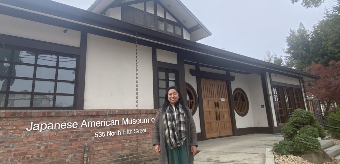 A woman stands in front of the Japanese American Museum in San Jose, California