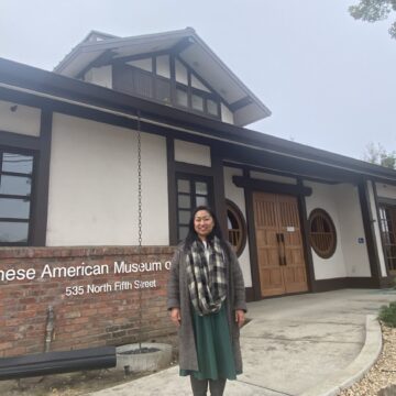 A woman stands in front of the Japanese American Museum in San Jose, California