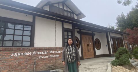 A woman stands in front of the Japanese American Museum in San Jose, California