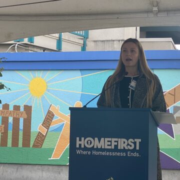HOMEFIRST MEMORIAL 2025 SAN JOSE-- Karlee Douglass A woman speaking at a podium during a memorial for homeless people in San Jose, California
