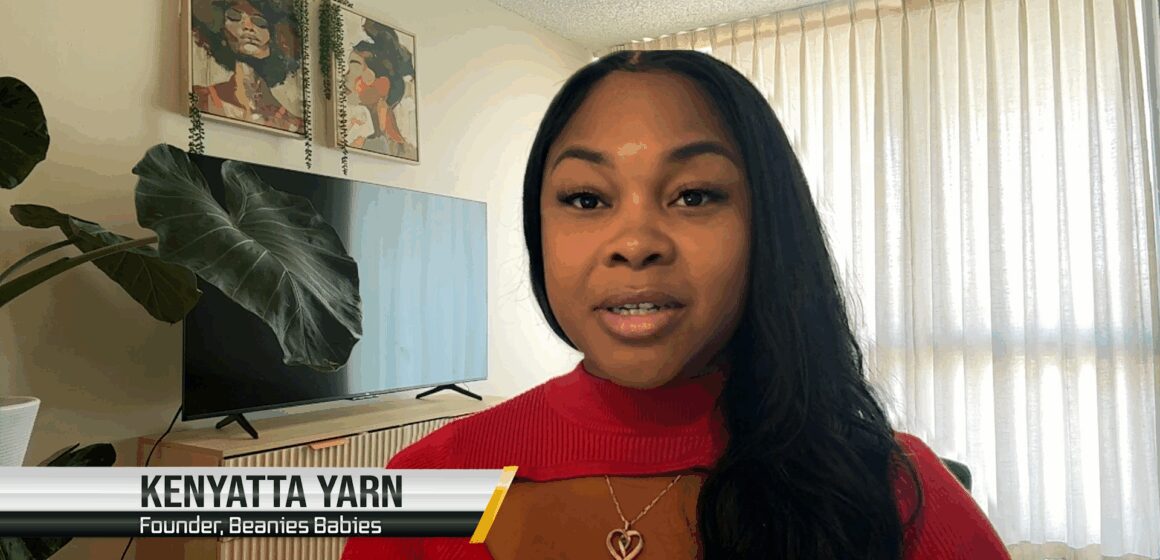Kenyatta Yarn Dying to Stay Here A Black woman sitting inside her home, with a plant, tv and blinds in the background