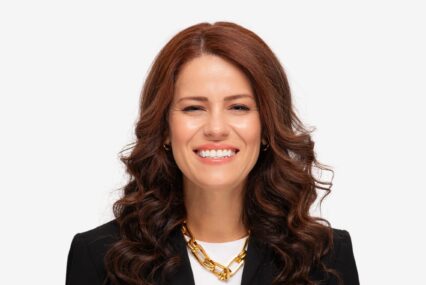 A woman smiles in a professional headshot.