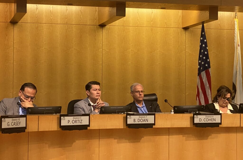 People sitting at a local government meeting in San Jose, California