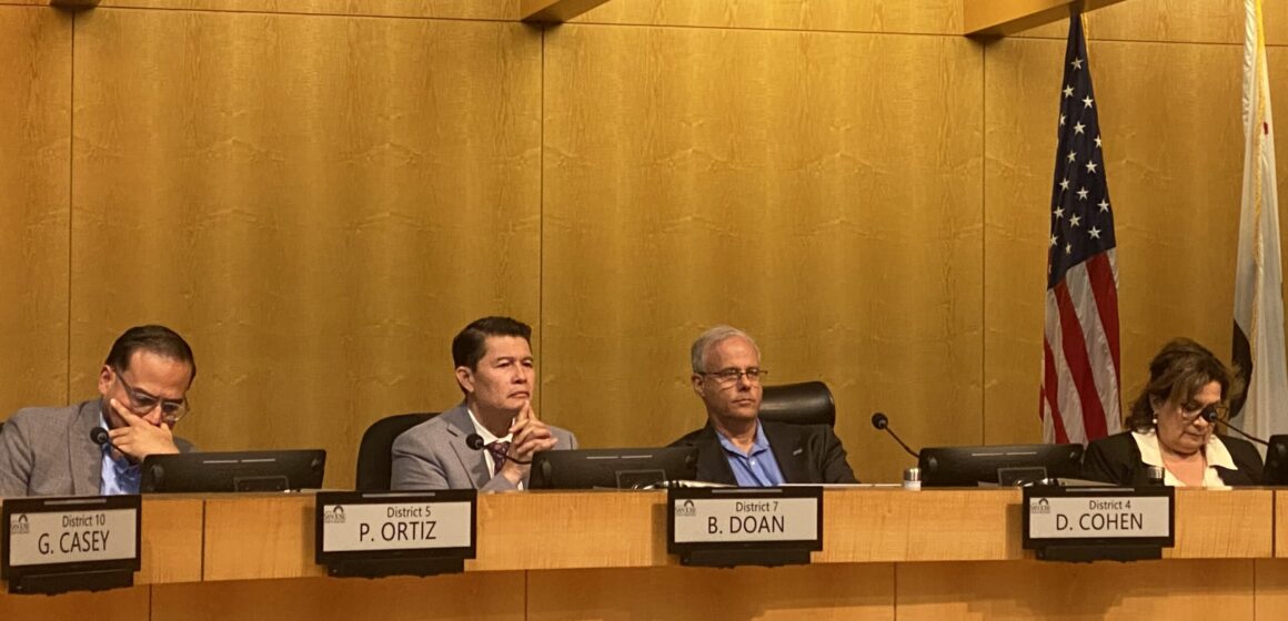 People sitting at a local government meeting in San Jose, California