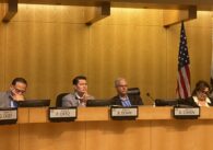 People sitting at a local government meeting in San Jose, California