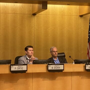 People sitting at a local government meeting in San Jose, California