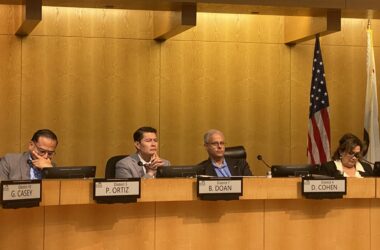 People sitting at a local government meeting in San Jose, California