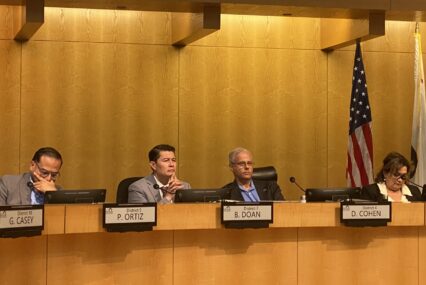People sitting at a local government meeting in San Jose, California