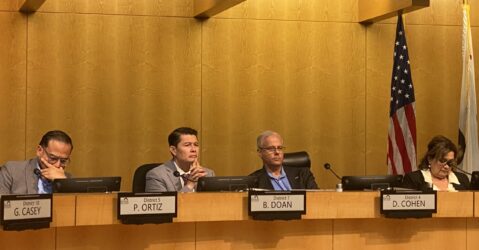 People sitting at a local government meeting in San Jose, California