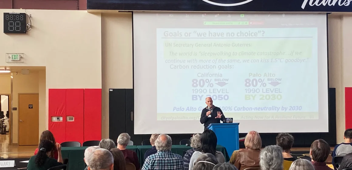 Man speaking to a group of people in a room.