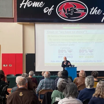 Man speaking to a group of people in a room.