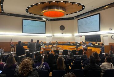 BOS People in audience seating at a government meeting in Santa Clara County, California