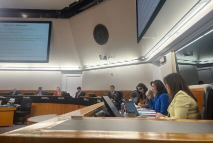 A group of people sitting behind a dais at a government meeting in Santa Clara County, California