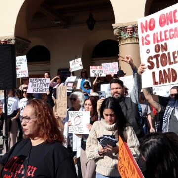 A group of people rally against federal immigration enforcement in San Jose, California