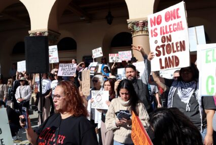 A group of people rally against federal immigration enforcement in San Jose, California