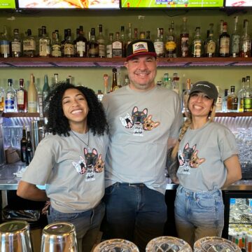 Three restaurant workers looking at the camera